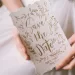 A bride holding her save the date cards.