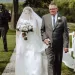 A bride walking down the aisle with her dad.