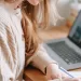 A bride writing notes from her laptop.