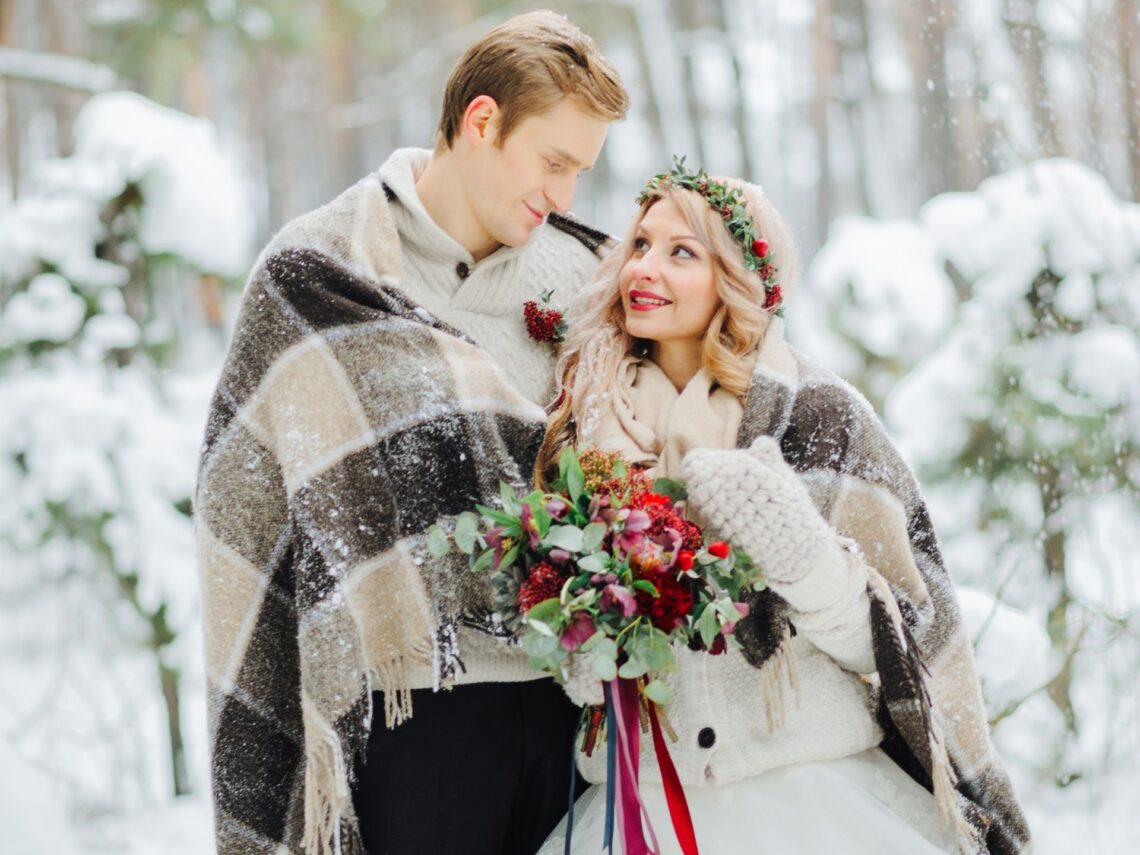 A bride and groom in the snow.