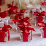 A table with mini red gifts on top.