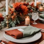 A burnt orange and sage green wedding table.