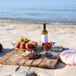 A couple having a picnic on the beach.