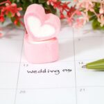 A calendar with red and pink flowers on tops.