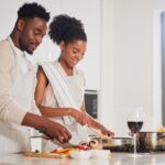 A man and women cooking together.
