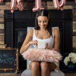 A bride to be opening presents at her bridal shower.