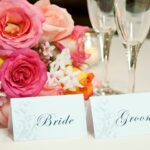 A wedding table with bride and groom place cards.