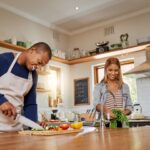 A couple cooking a meal together.