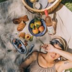 A girl having a picnic in her backyard.