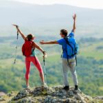 A couple hiking a mountain together.