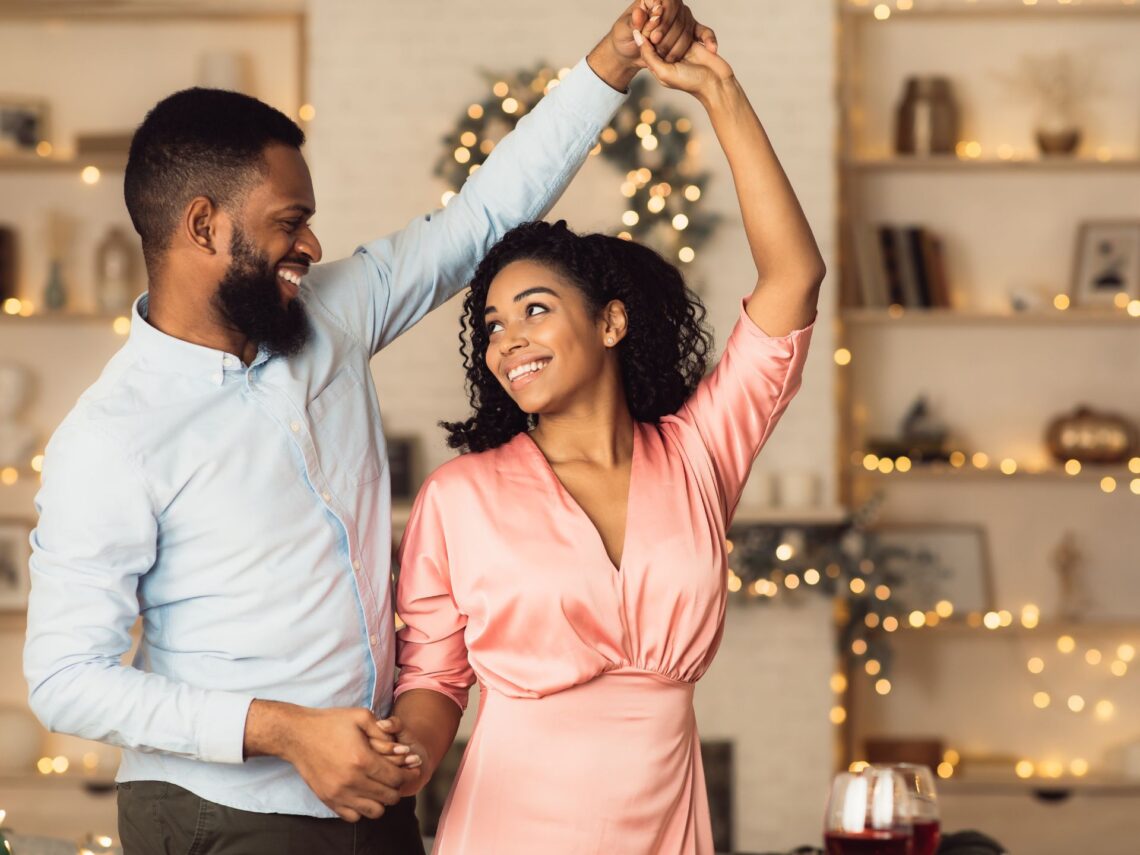 A couple dancing in their living room.