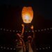 A couple releasing a lantern into the sky.