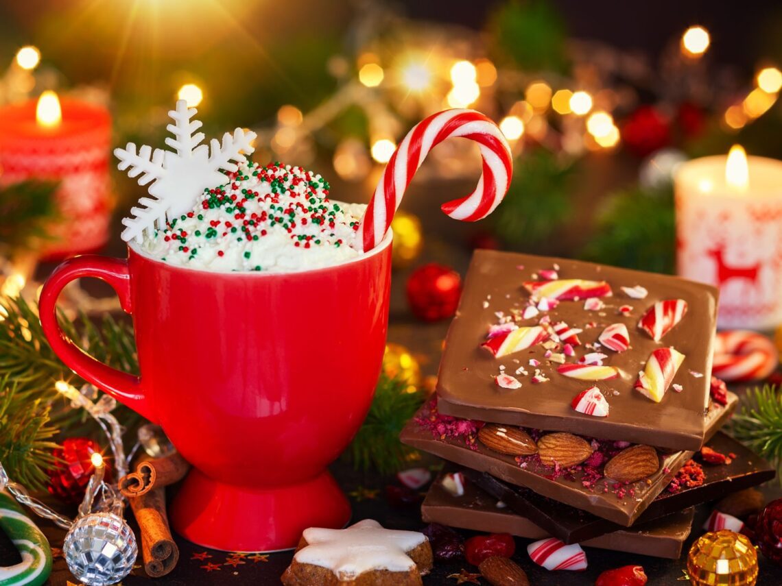 A table with hot chocolate and Christmas candy bark.