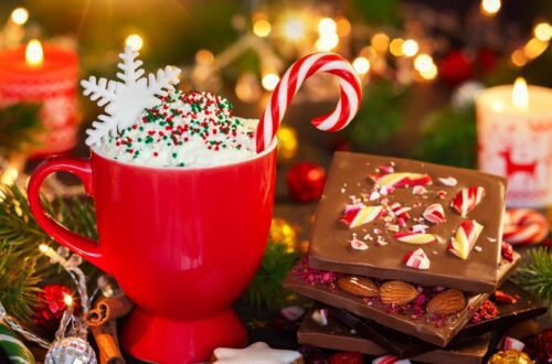 A table with hot chocolate and Christmas candy bark.