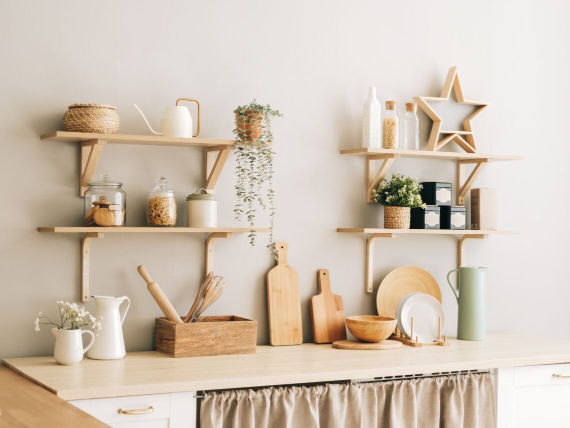 A white colored kitchen with light wood accents.