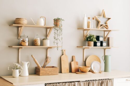 A white colored kitchen with light wood accents.