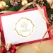 A table with ornaments and a red wedding invitation.