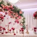 A wedding venue decorated with red and pink colored roses.