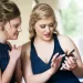 Two bridesmaids wearing navy blue colored dresses.