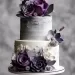 A table with a wedding cake that has purple and grey flowers on it.