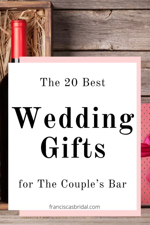 A wooden table with a wine bottle and a gift box.