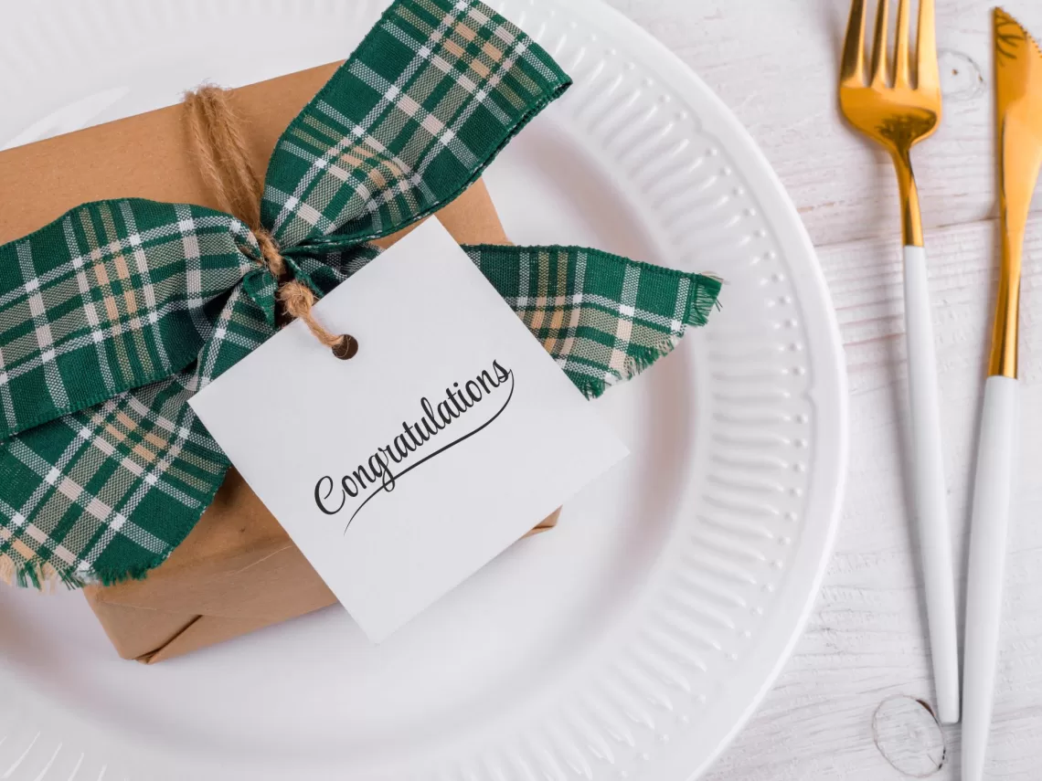 A table with a wedding gift on top.