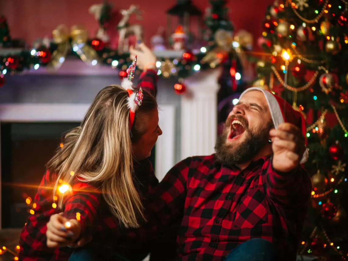 A couple wearing matching christmas shirts.