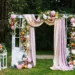A wedding arch with pastel floral garland.