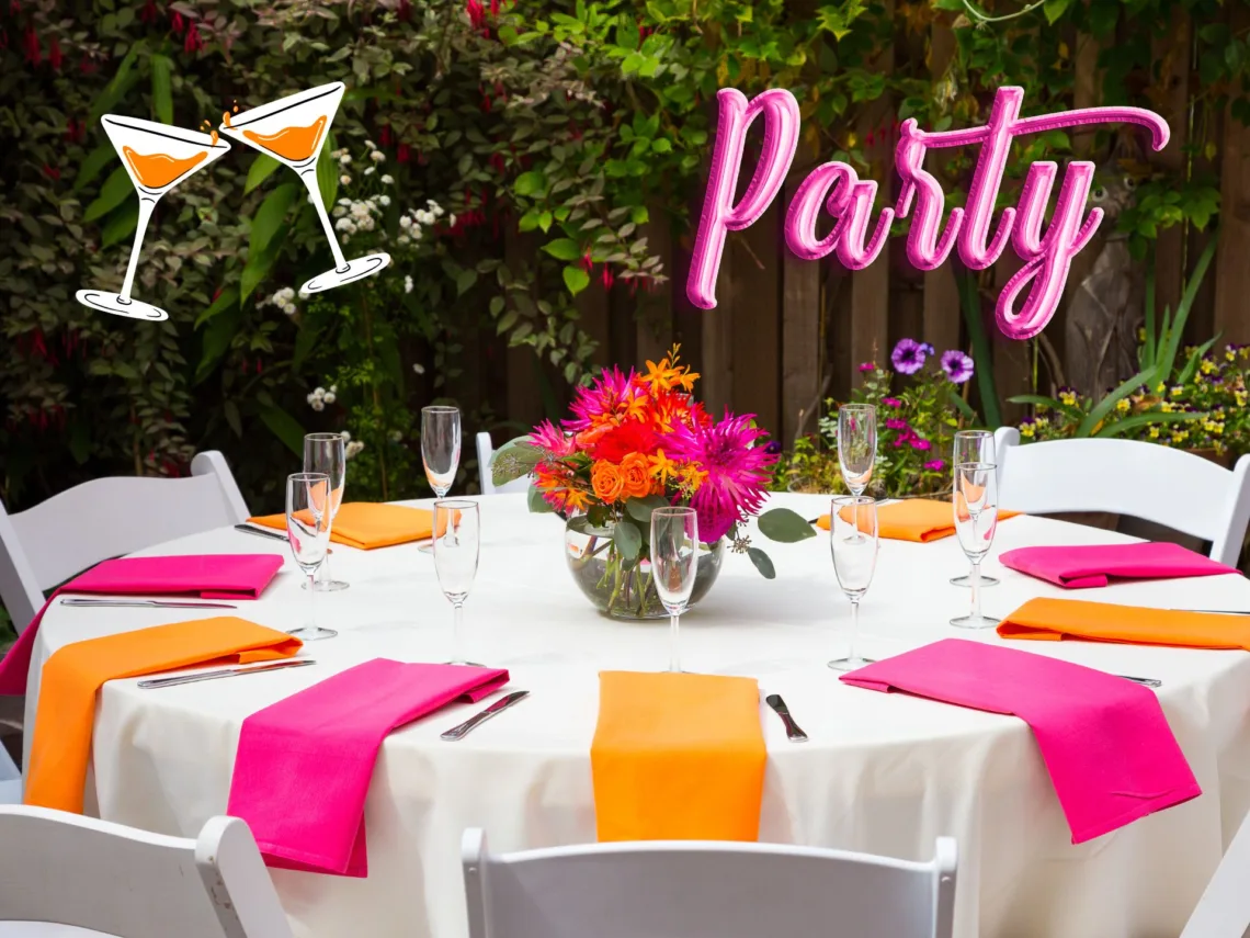 An outdoor bridal shower with hot pink and bright orange decorations.