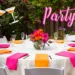 An outdoor bridal shower with hot pink and bright orange decorations.
